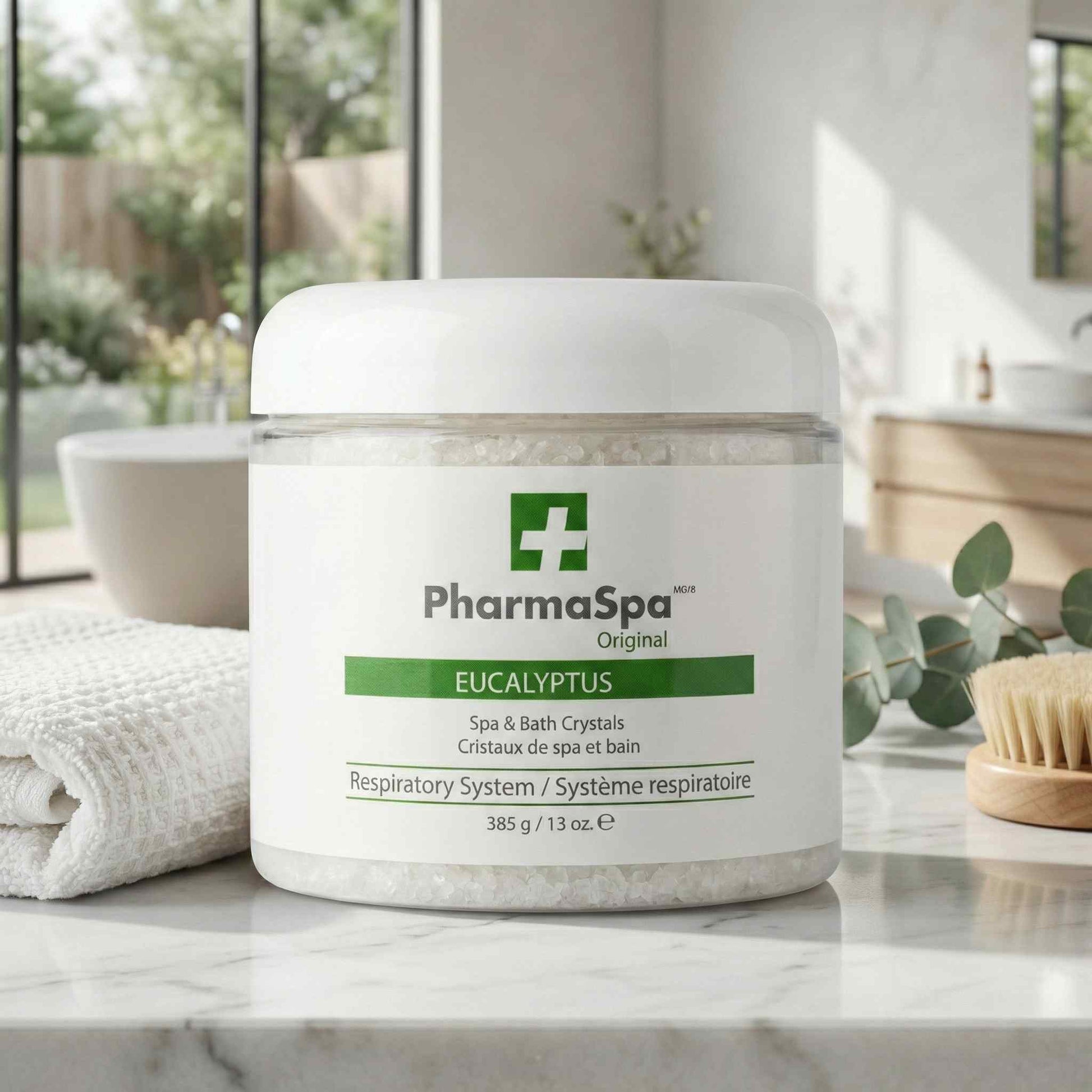 White jar of PharmaSpa Eucalyptus spa crystals displayed on a counter with greenery and a wooden brush