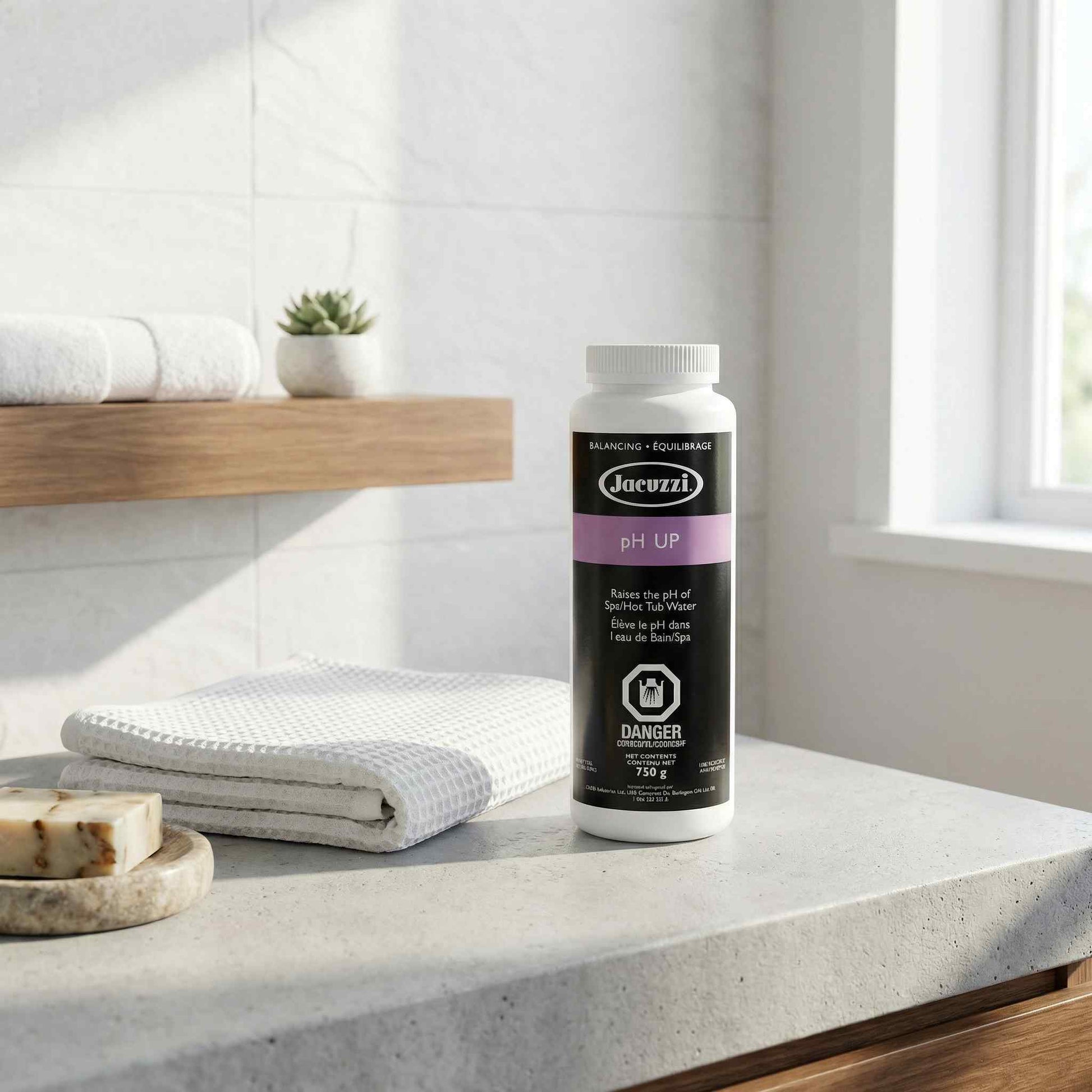 Bottle of pH UP product on a bathroom counter with towels and soap.