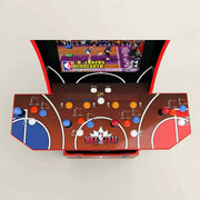 Close-up of NBA Jam arcade control panel with basketball-court design, joysticks, and colour buttons