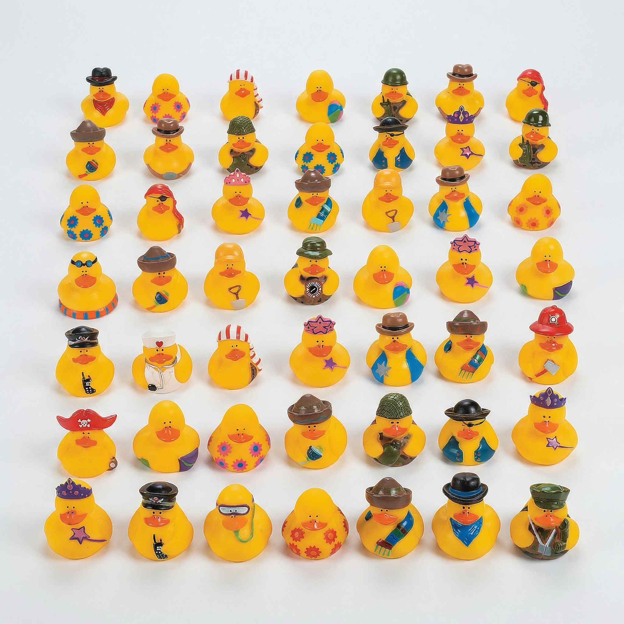 Collection of 30+ assorted novelty mini rubber ducks in various costumes arranged in rows