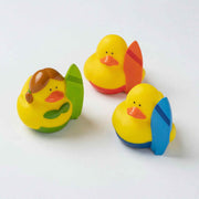 Four colourful mini rubber ducks in Hawaiian theme wearing leis and tropical accessories