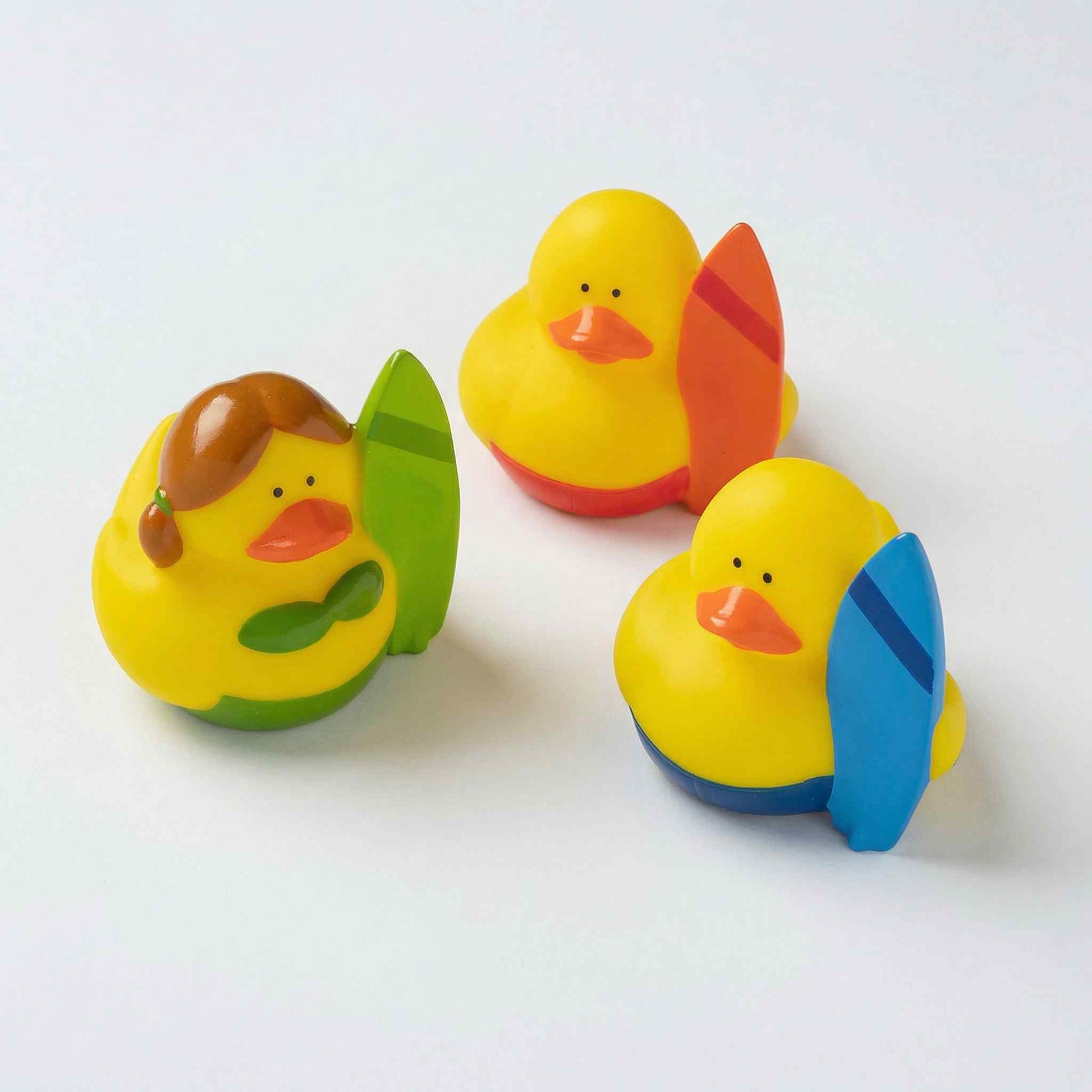 Four colourful mini rubber ducks in Hawaiian theme wearing leis and tropical accessories