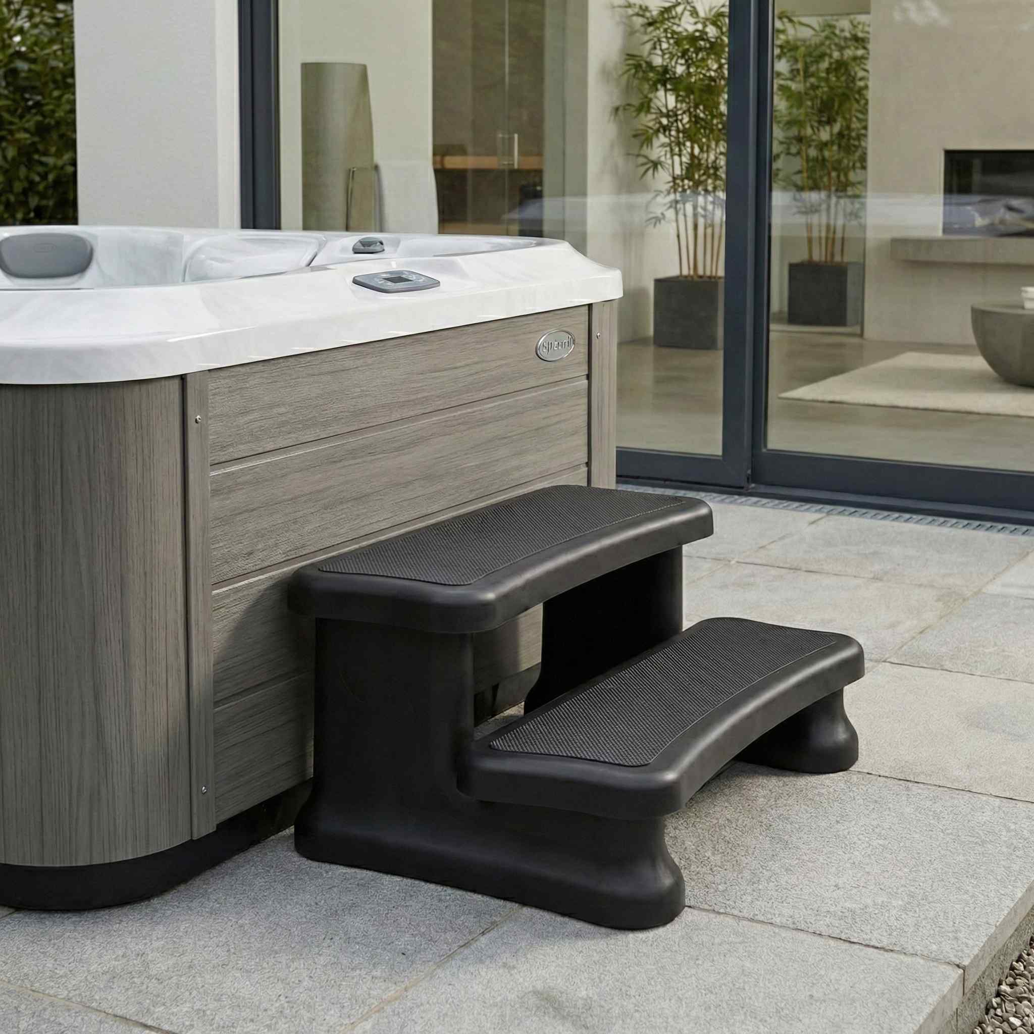 SmartStep displayed beside a hot tub on a modern patio with glass sliding doors