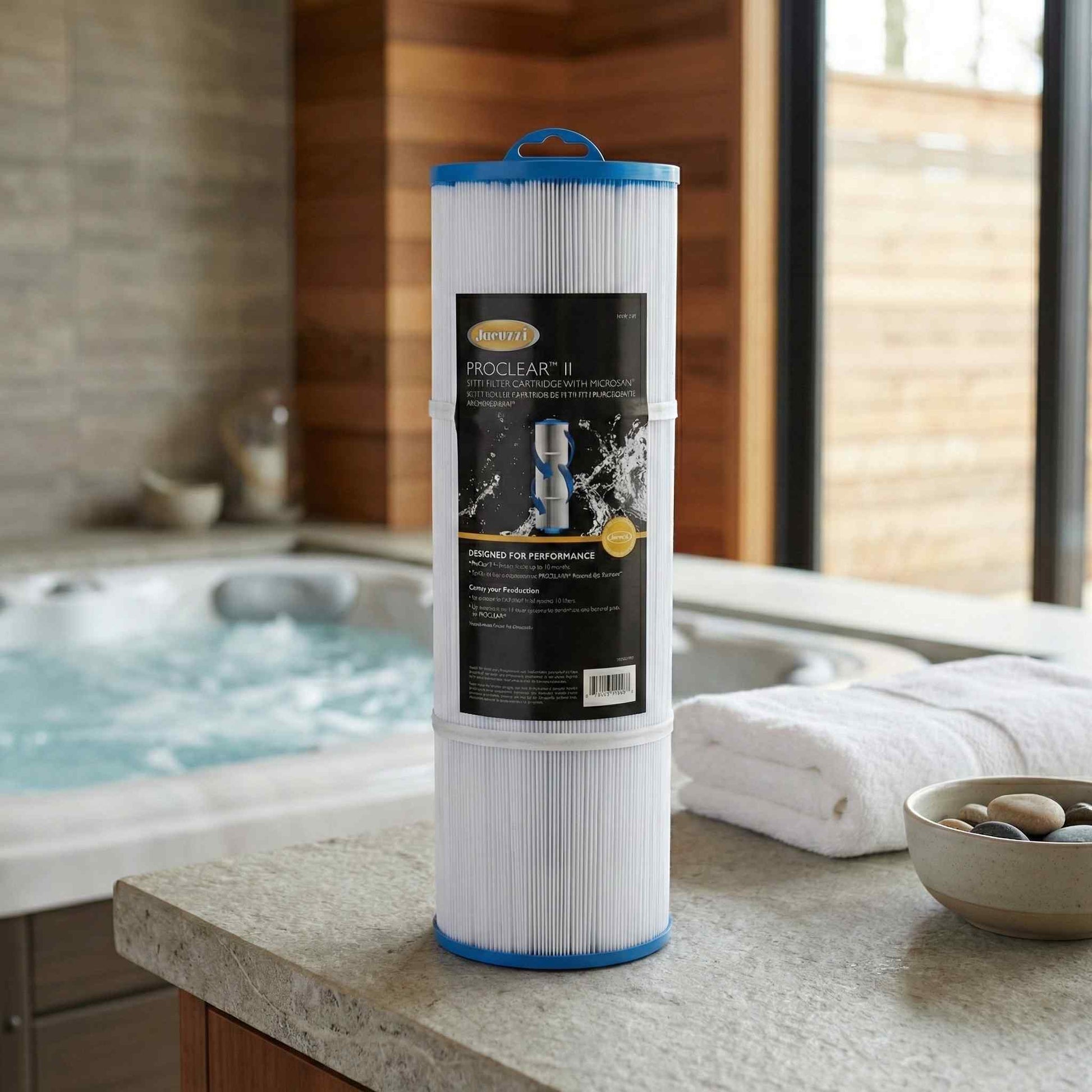 Jacuzzi® 75sqft J-400 Series Filter on a countertop with a hot tub in the background