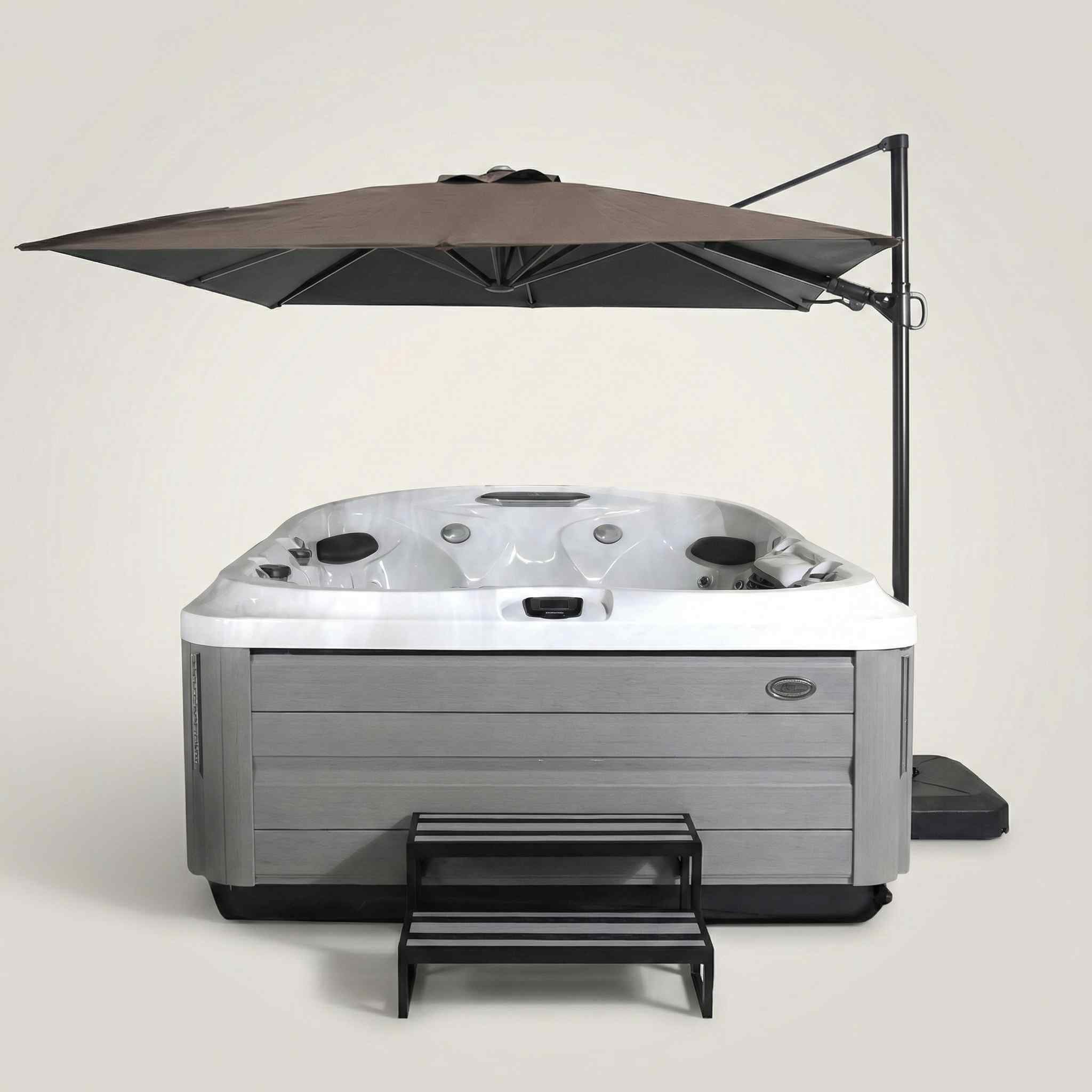 Jacuzzi® Umbrella Articulating Square Sienna shading a Jacuzzi hot tub on a patio with outdoor lounge furniture
