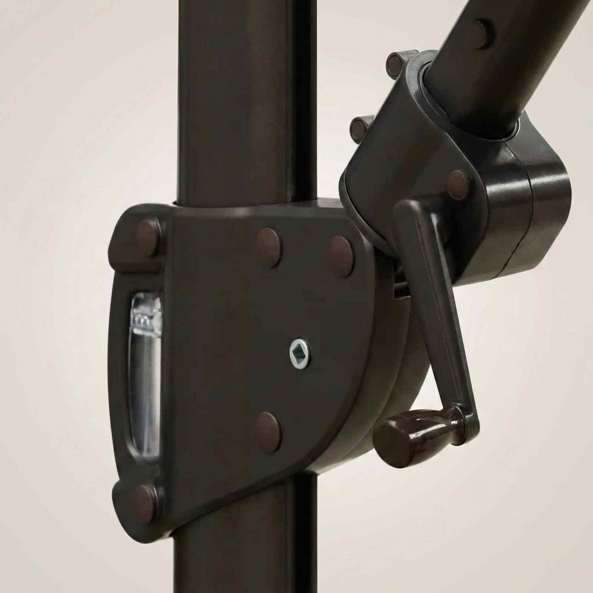 Close-up of the bronze tilt and rotation joint mechanism on the umbrella pole