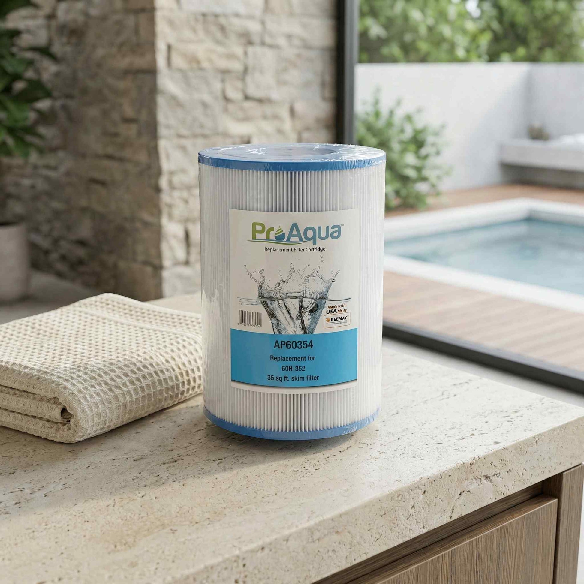 ProAqua pool filter cartridge on a countertop with a pool in the background