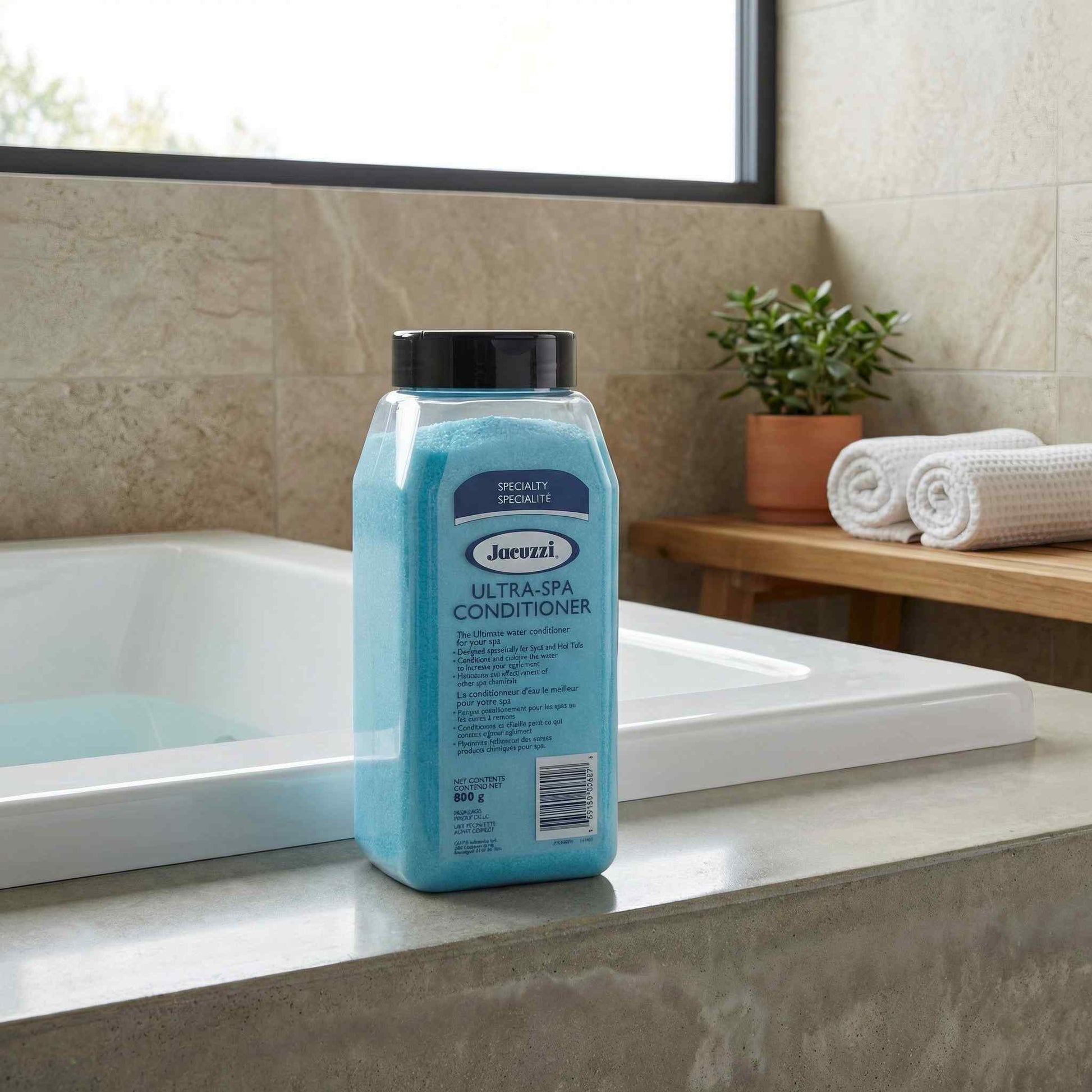 Jacuzzi® Ultra Spa, 800 g – Spa Sanitizer Granules displayed on a patio ledge beside a hot tub in a lifestyle setting
