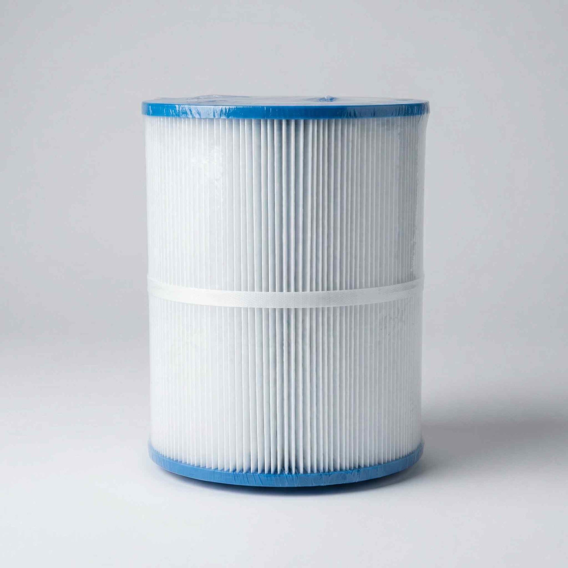 Cylindrical filter cartridge with blue rim on a gray background