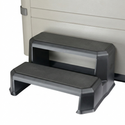 Step stool with textured surface against a hot tub.